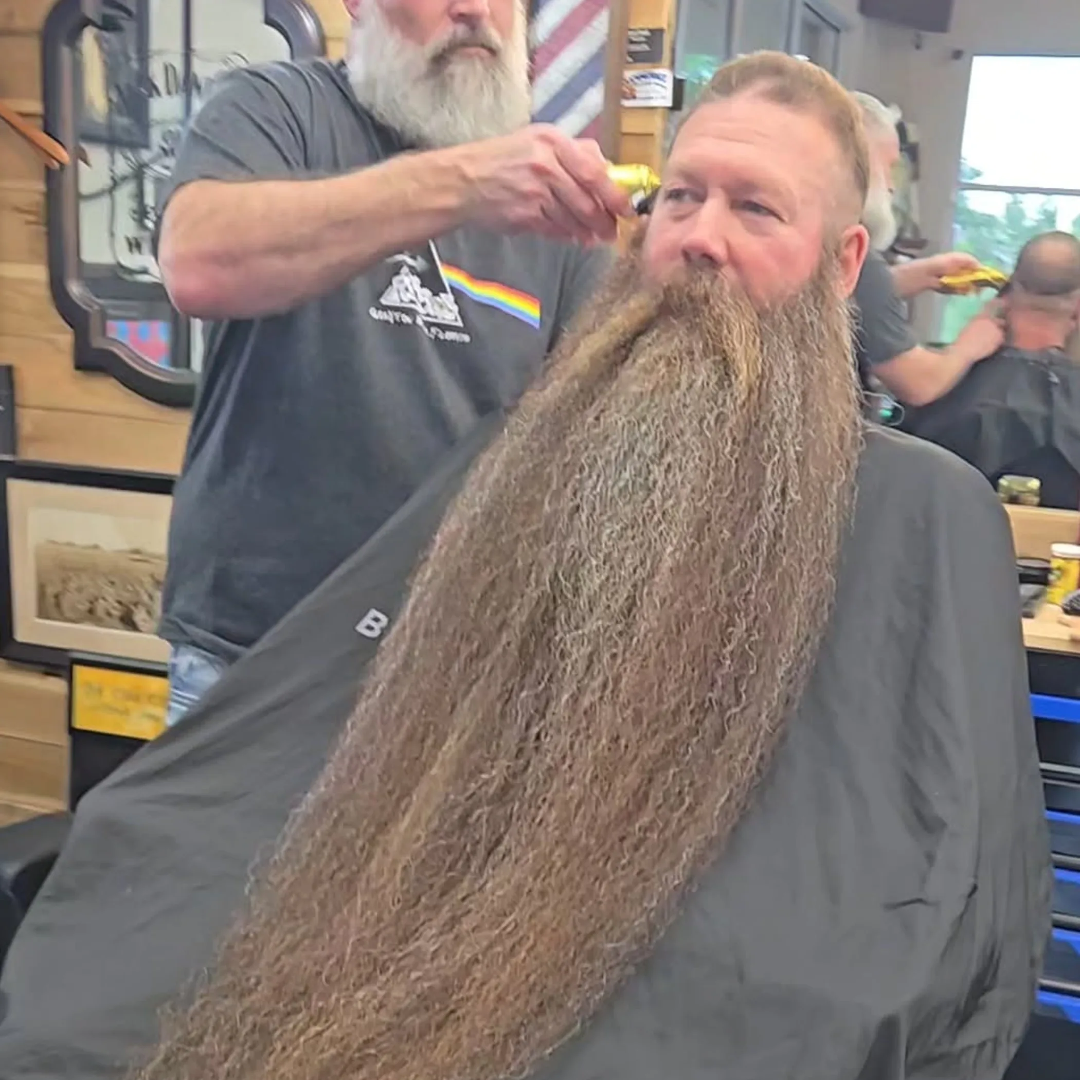 man grooming beard with comb