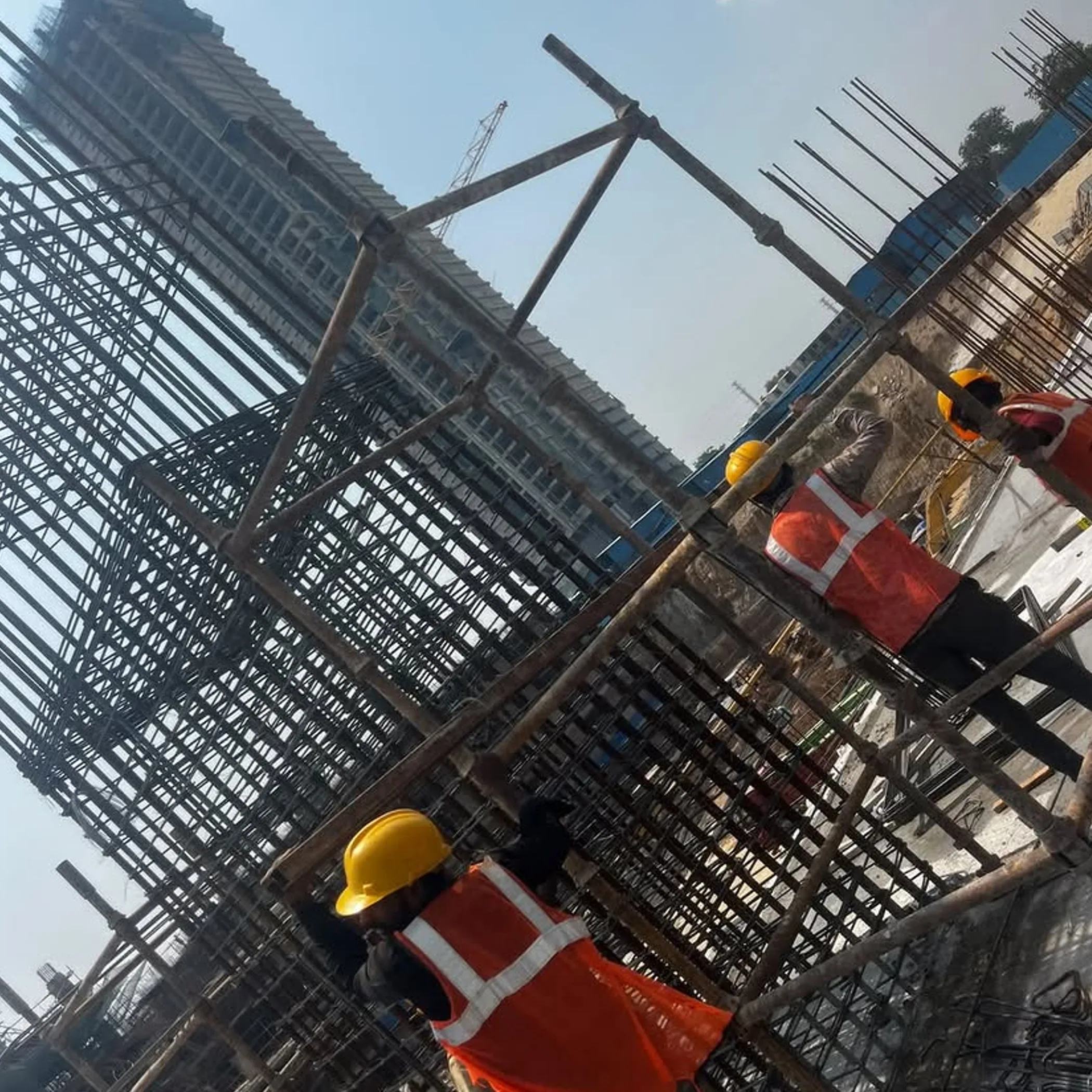 workers reinforcing high-rise construction site